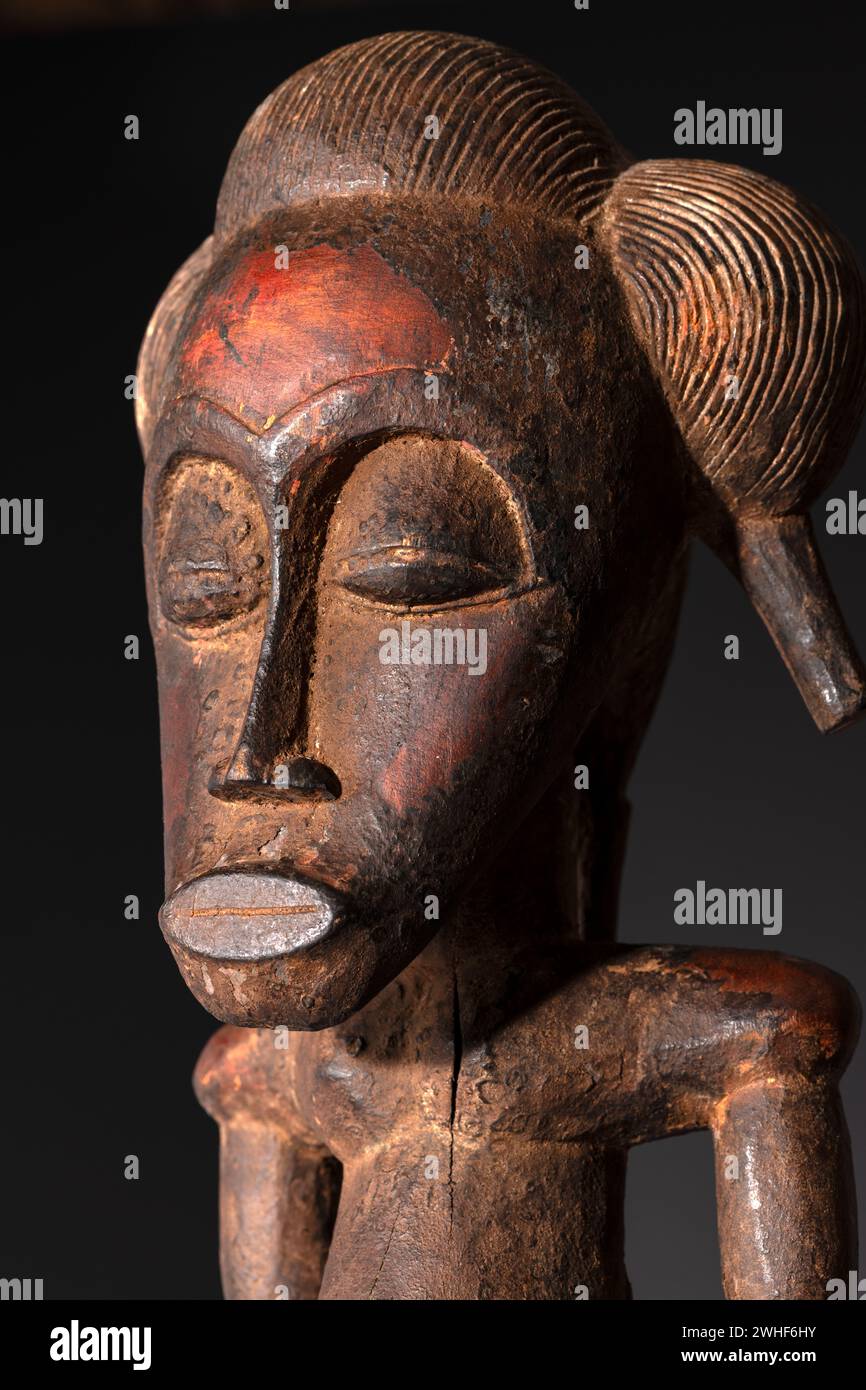 Nahaufnahme einer hölzernen Senufo männlichen Figur aus der Elfenbeinküste. Afrikanische Kunst mit meisterhafter Handwerkskunst und spirituellem Symbolismus. Stockfoto