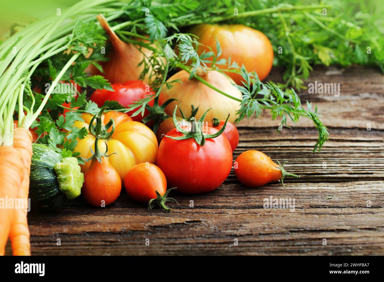Gemüse und Kräuter auf Holzhintergrund. Stockfoto
