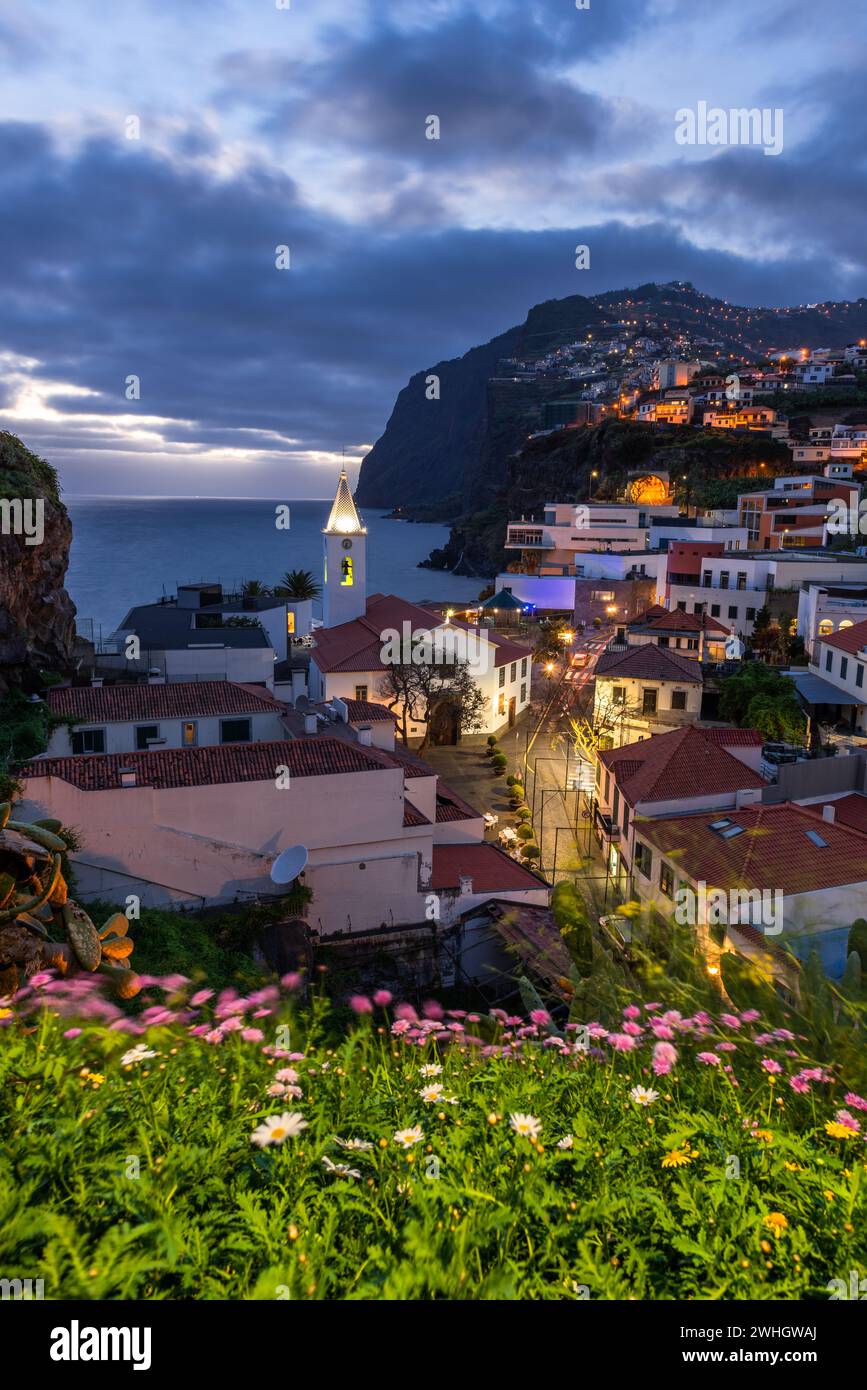 Stadtbild von Camara de Lobos in der Abenddämmerung beleuchtete Architektur der Küstenstadt auf Madeira, Portugal Stockfoto