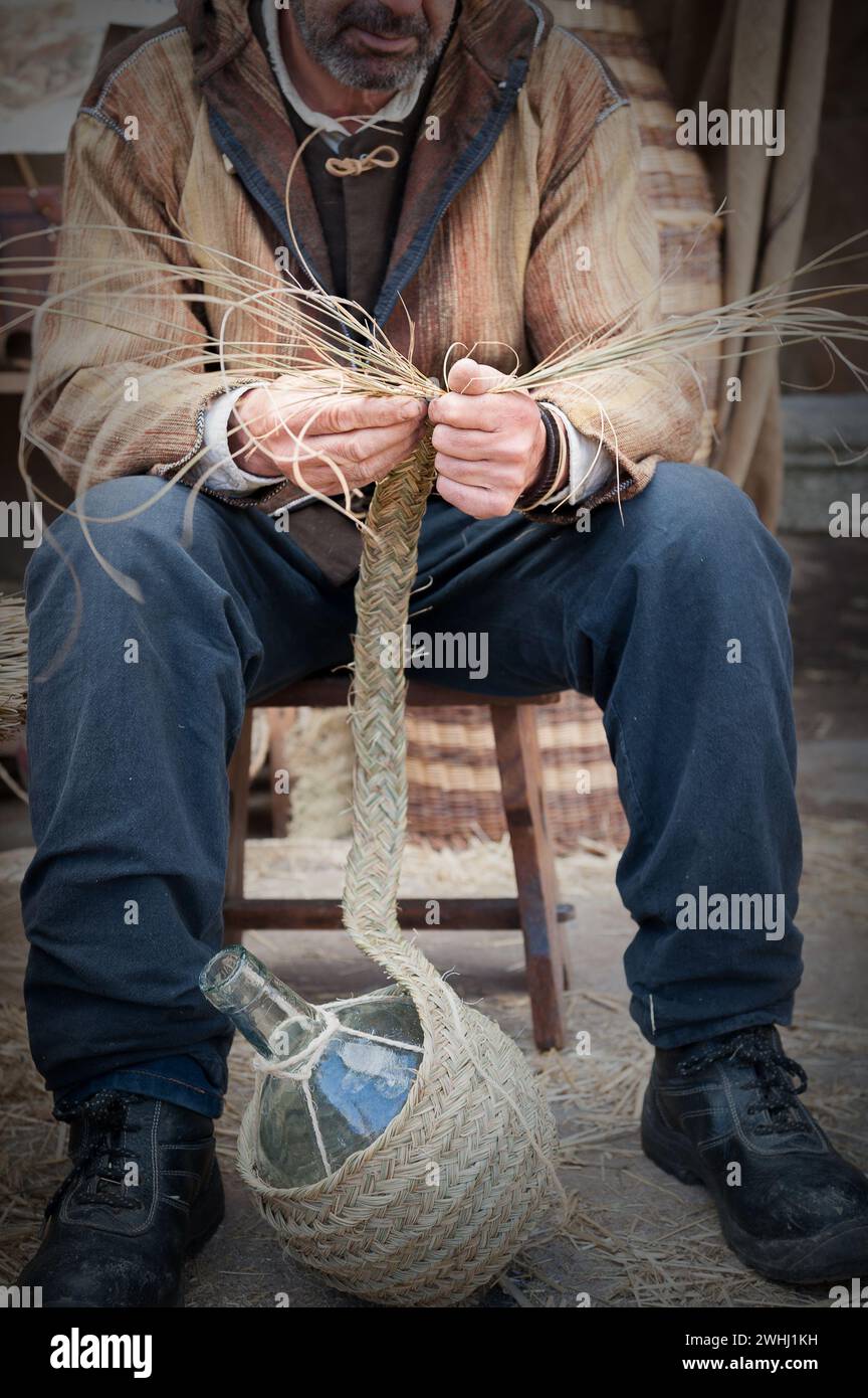 Nahaufnahme eines Mannes, der Korbgeflecht bearbeitet, um ein Endprodukt herzustellen Stockfoto