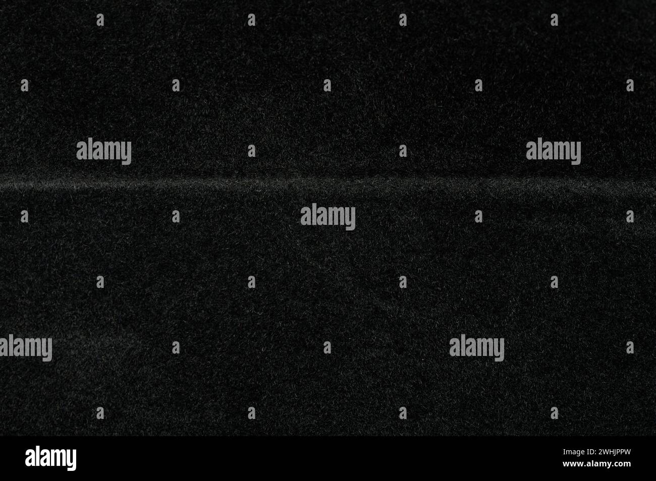 Hintergrundmakro mit verschwommener schwarzer Velours-Textur, Nahansicht Stockfoto