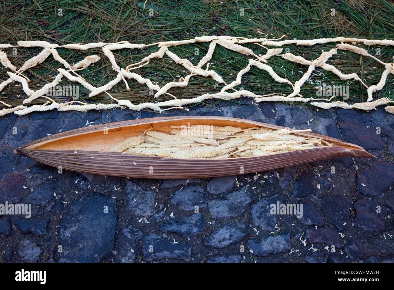Antigua, Guatemala. Der Inhalt einer Kapsel der Corozo-Palme wird verwendet, um einen Rand entlang einer Alfombra (Teppich) aus Blumen, Kiefernnadeln und anderen zu bilden Stockfoto