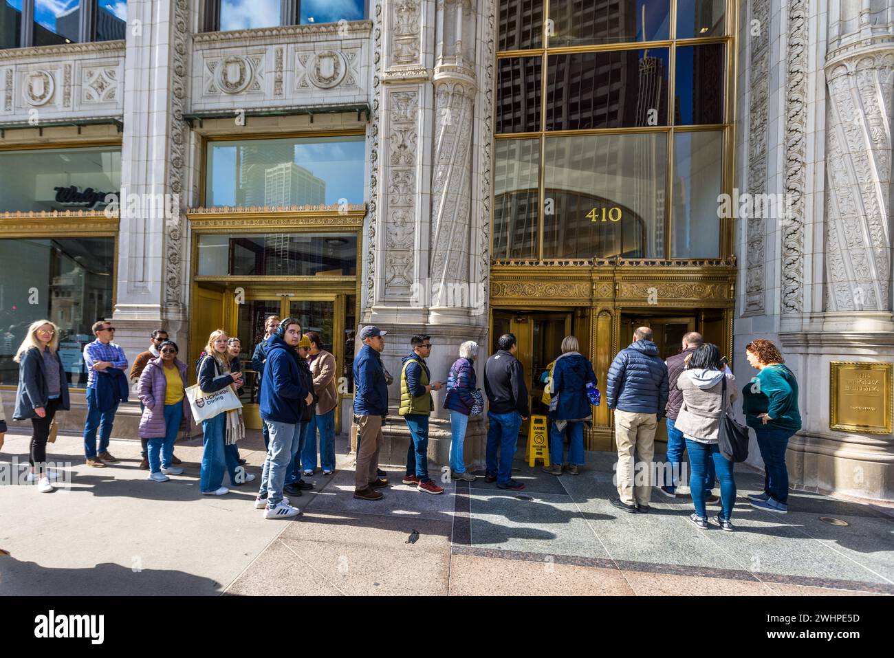 Schlange vor dem Wrigley Building während des Open House Chicago. Das Wrigley Building ist ein Wolkenkratzer an der Magnificent Mile in Chicago, Illinois. Es wurde 1920 als Hauptquartier des Kaugummimagnaten William Wrigley Jr. erbaut Chicago, Illinois, Usa Stockfoto
