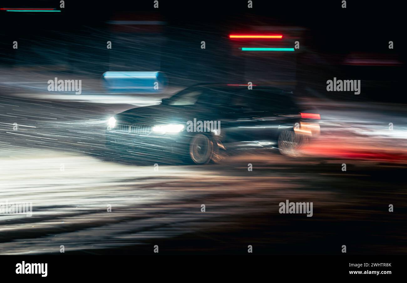 Verschwommenes Auto auf der Stadtstraße, nächtliche Landschaft Stockfoto
