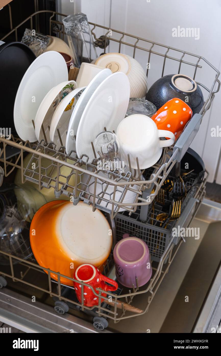 In der Geschirrspülmaschine gab es viel dreckiges Geschirr. Der Gastgeberin helfen, Ökonomie und Ökologie. Reinigung in der Küche Stockfoto