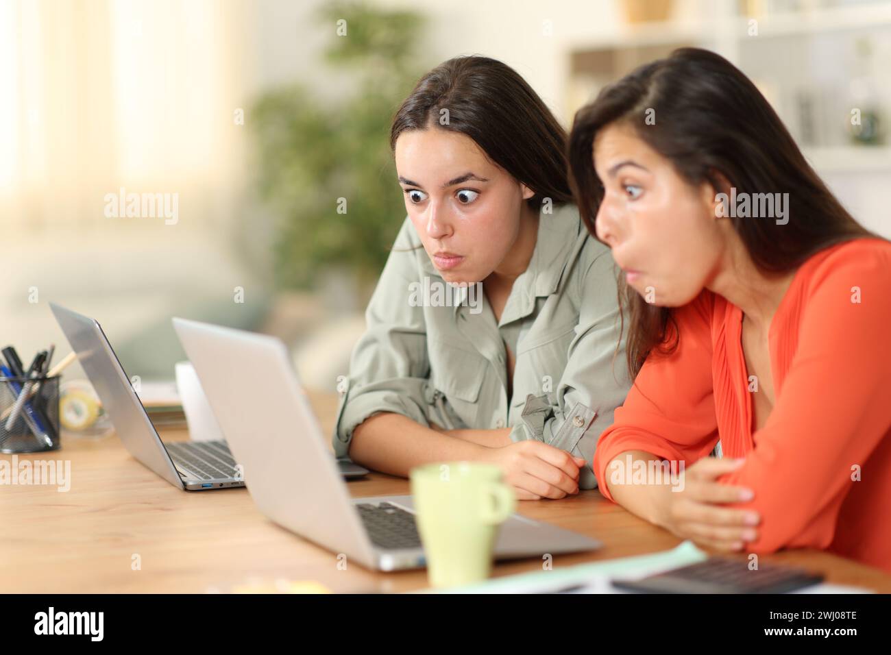 Verwirrte freiberufliche Mitarbeiter, die zu Hause einen Laptop überprüfen Stockfoto