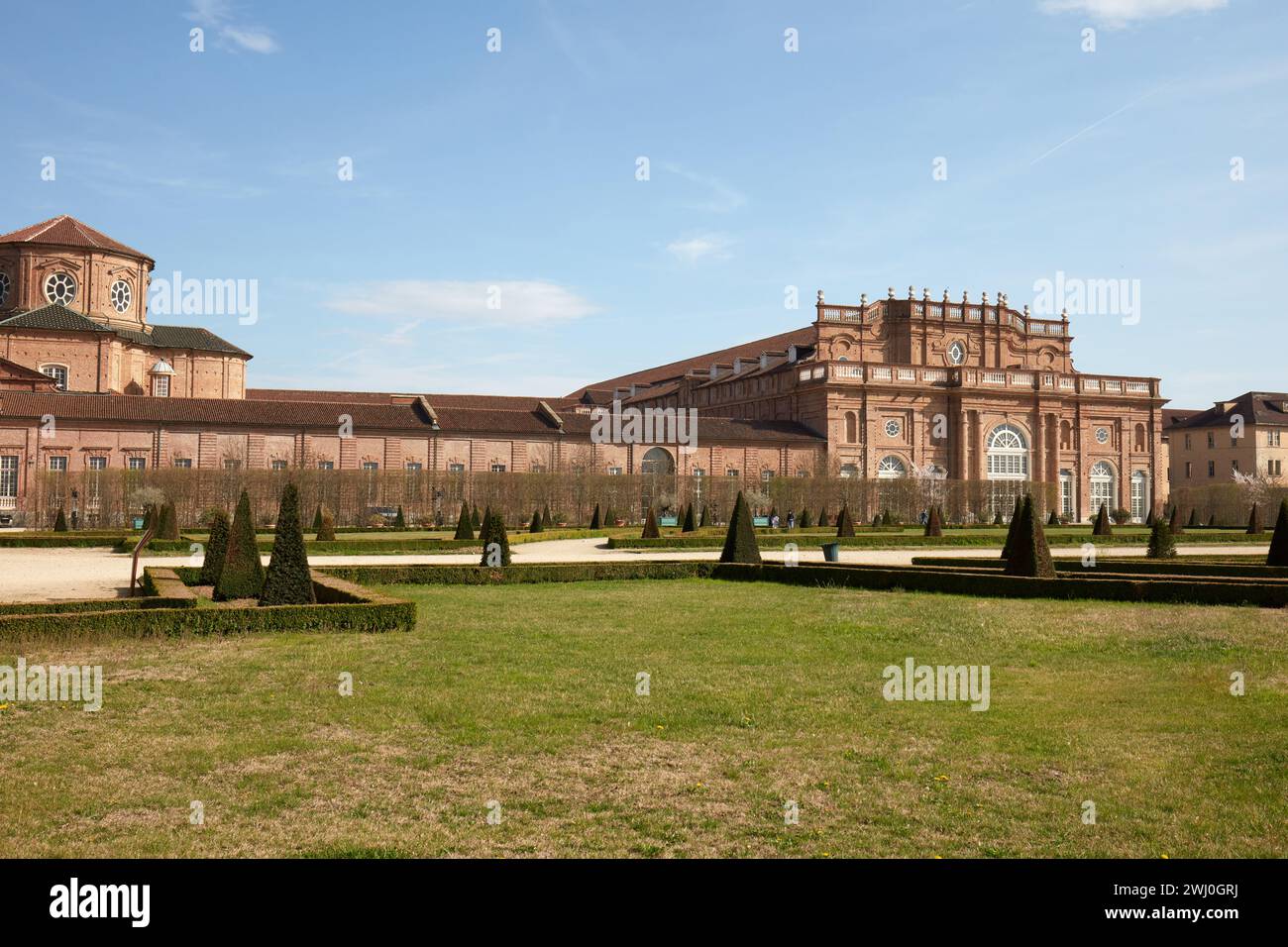 VENARIA REALE, ITALIEN - 29. MÄRZ 2023: Architektur und Park der Burg Reggia di Venaria mit pyramidalen Hecken im Frühlingssonnenlicht Stockfoto