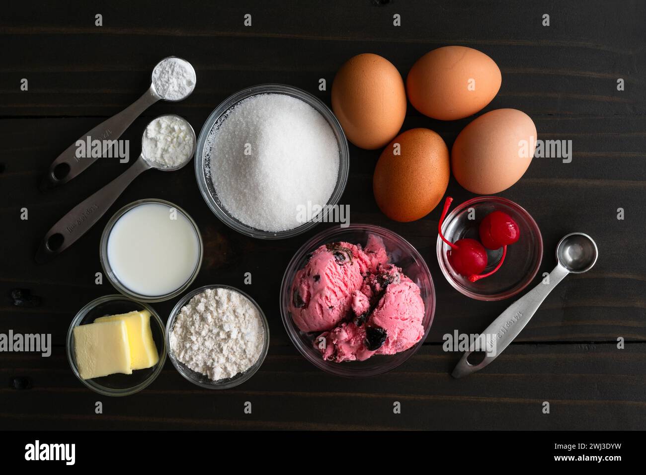 Zutaten zur Herstellung von Miniatur-Versionen von gebackenem Alaska: Eis, Eier, Zucker und Zutaten für Biskuitkuchen und Meringue für Mini-Desserts Stockfoto