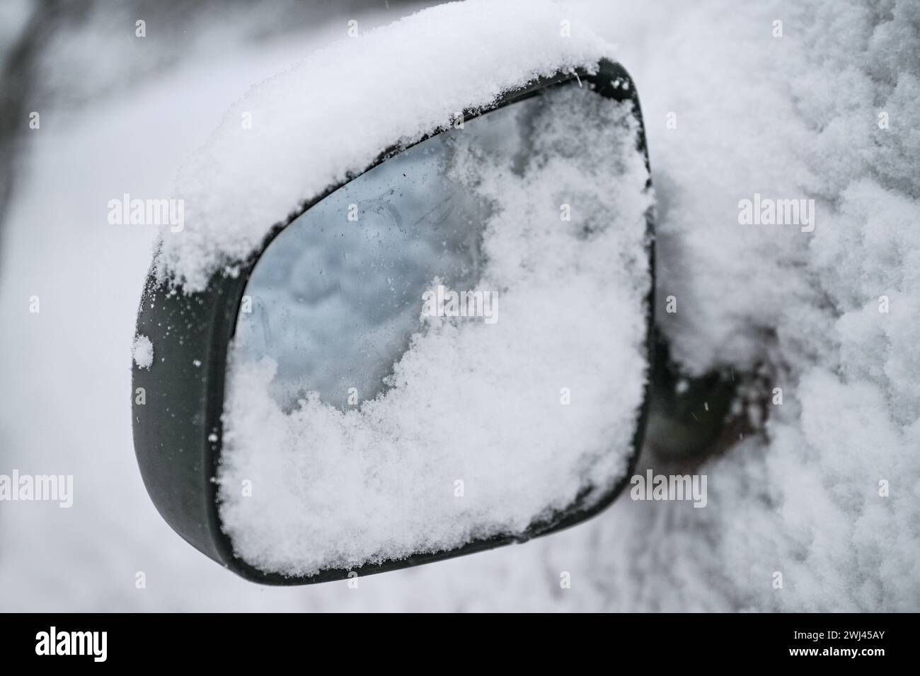 Schneebedeckter Seitenspiegel eines Autos, gefährliches Fahren im Winter, Kopierraum, ausgewählter Fokus Stockfoto