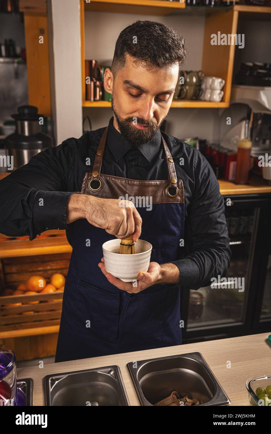 Barkeeper bereitet japanische Getränke Matcha Latte zu Stockfoto