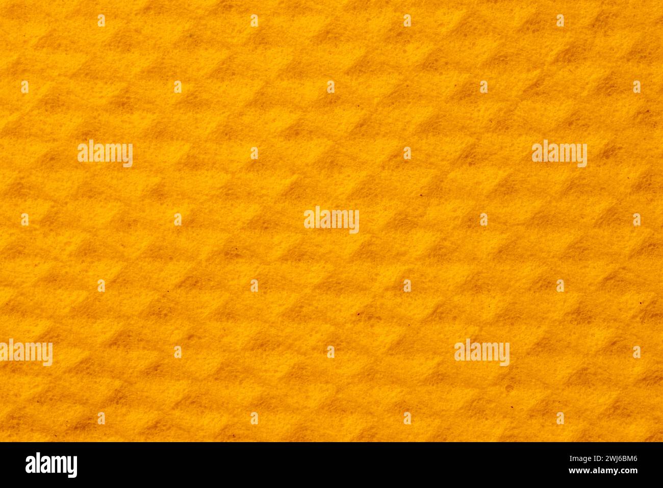 Die Textur der gelben Schwammtuchoberfläche als Hintergrund. Stockfoto