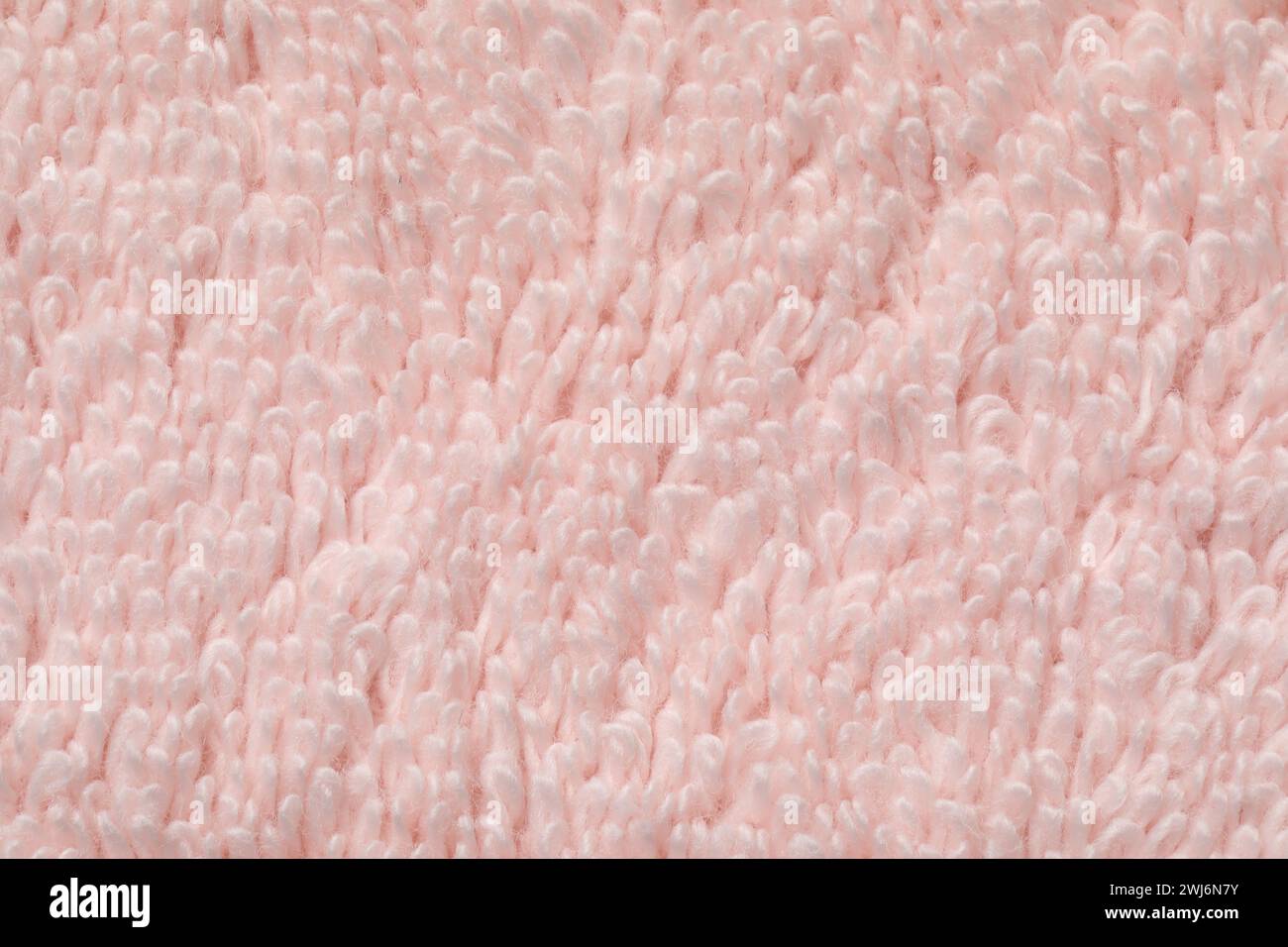 Textur aus weichem hellrosa Stoff als Hintergrund, Draufsicht Stockfoto