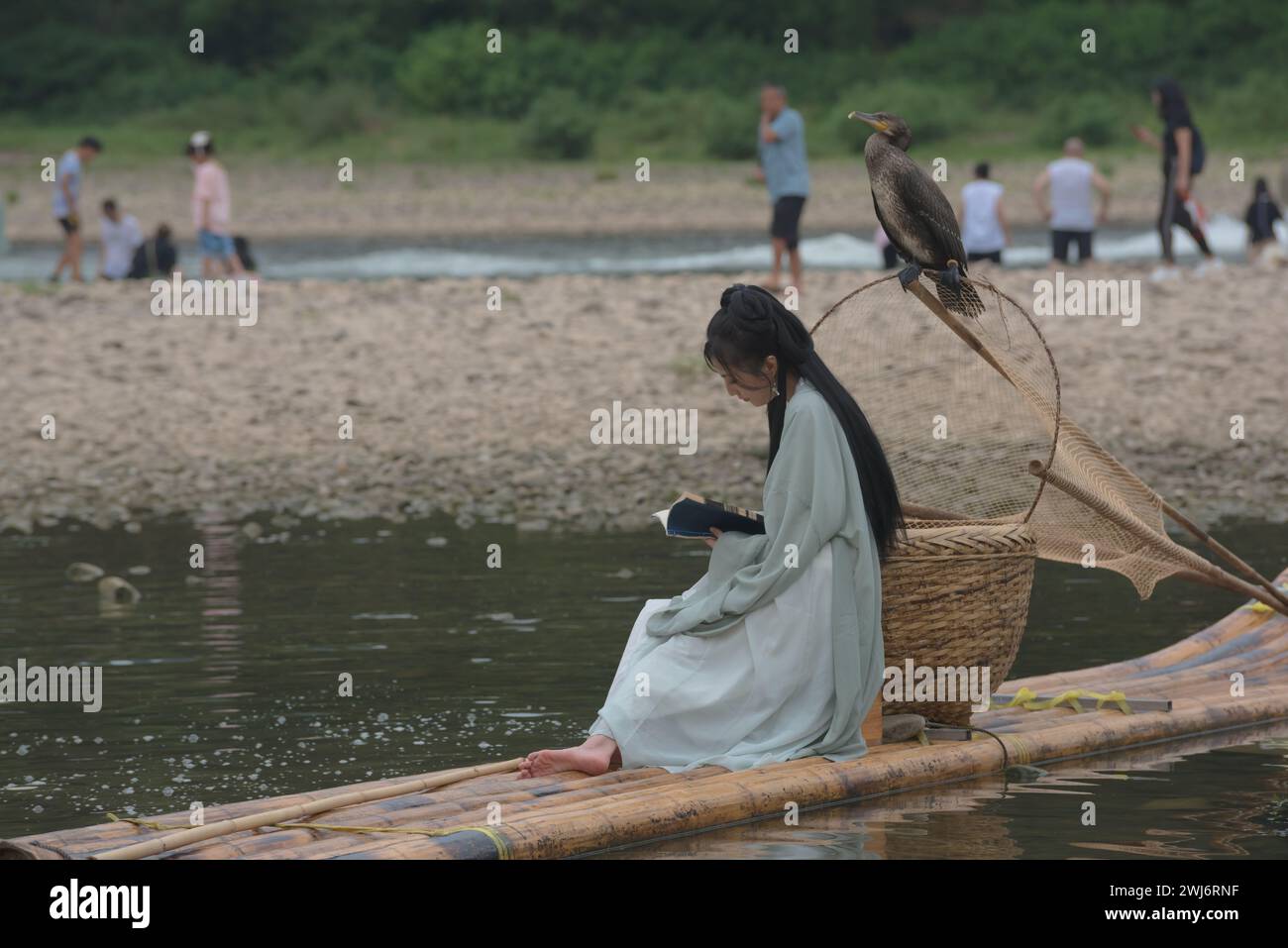 Yangshuo County, Guilin, Guangxi, China - 29. Juli 2023: Touristen in alten chinesischen Kostümen am Fluss Li Stockfoto