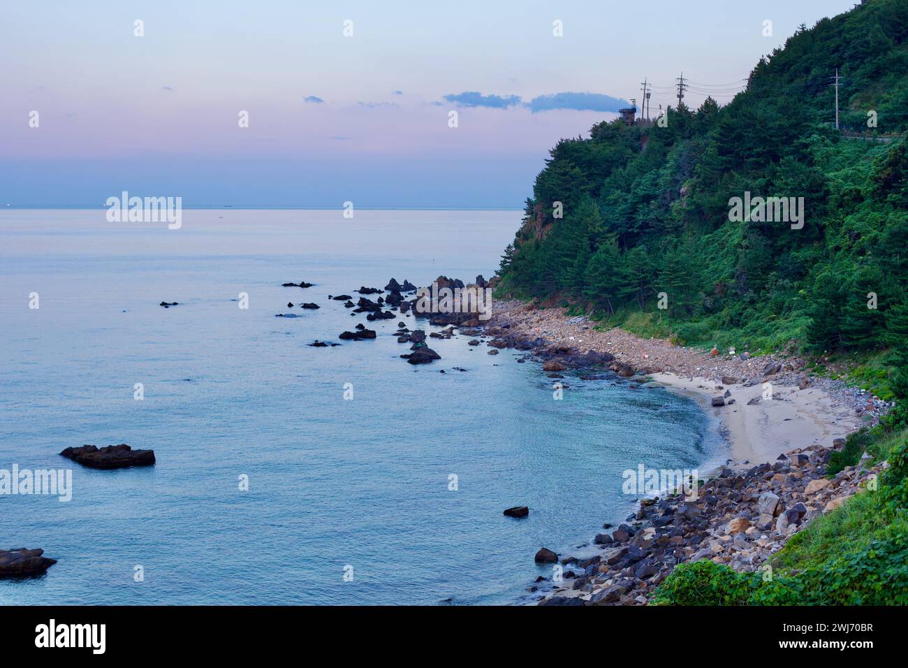 Gangneung City, Südkorea - 29. Juli 2019: Der felsige Hügel entlang der Küste von Gangneung, der nach Sonnenuntergang gefangen wurde und noch Licht in sich birgt Stockfoto