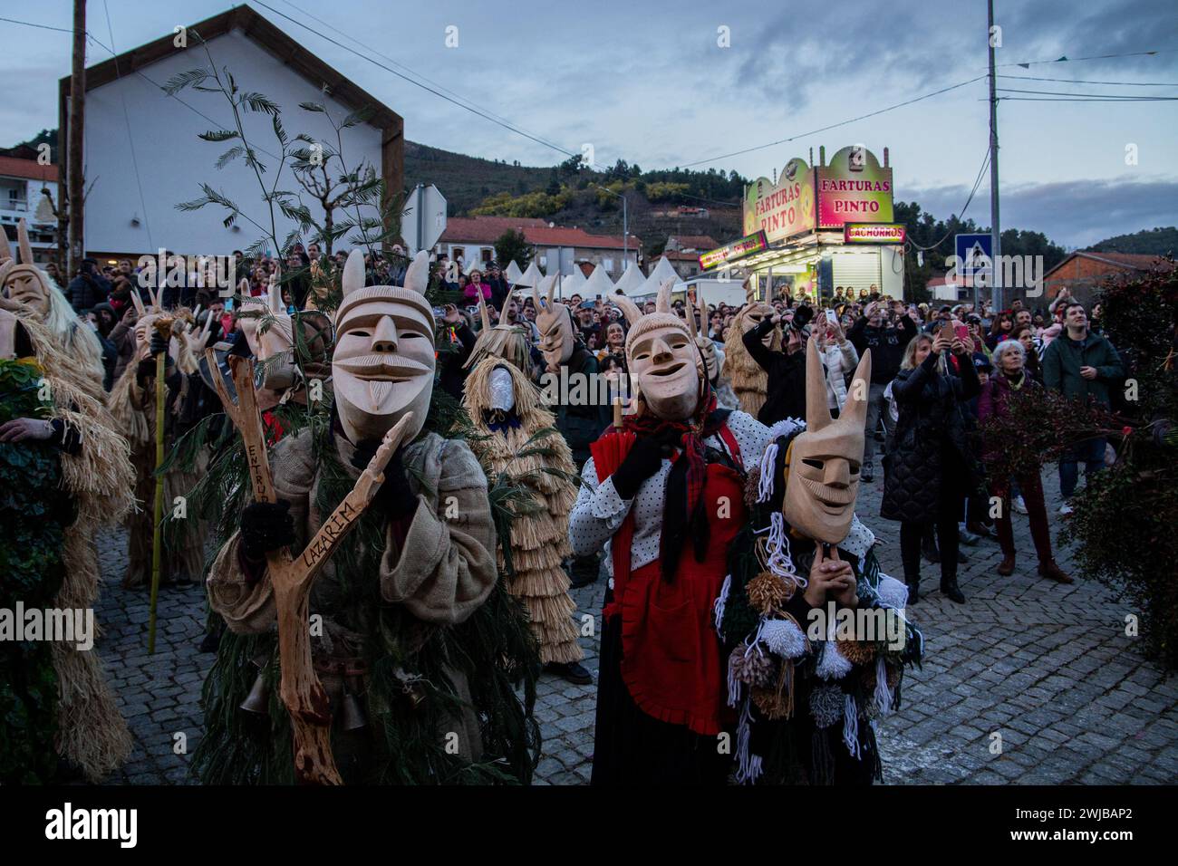 Lamego, Portugal. Februar 2024. Caretos sieht Gedichte von Spott und Fluch, die während des Lazarim-Karnevals zitiert wurden. Menschen in Karnevalskostümen nehmen an Entrudo in Lazarim Teil, einer kleinen Stadt in der Gemeinde Lamego im Norden Portugals. Es ist bekannt für seine teuflischen und geheimnisvollen Masken namens Caretos, die aus Holz gefertigt sind und gilt als einer der traditionellsten Karnevals Portugals, am 13. Februar 2024 in Lamego, Portugal. Quelle: SOPA Images Limited/Alamy Live News Stockfoto