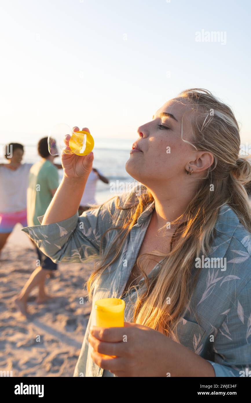 Die junge kaukasische Frau genießt eine Strandparty Stockfoto