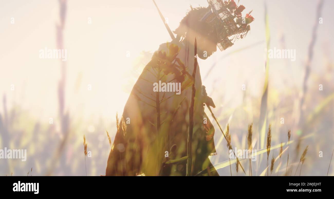 Frau, die in den Bergen wandert, mit traditioneller Kleidung, hohem Gras voraus Stockfoto