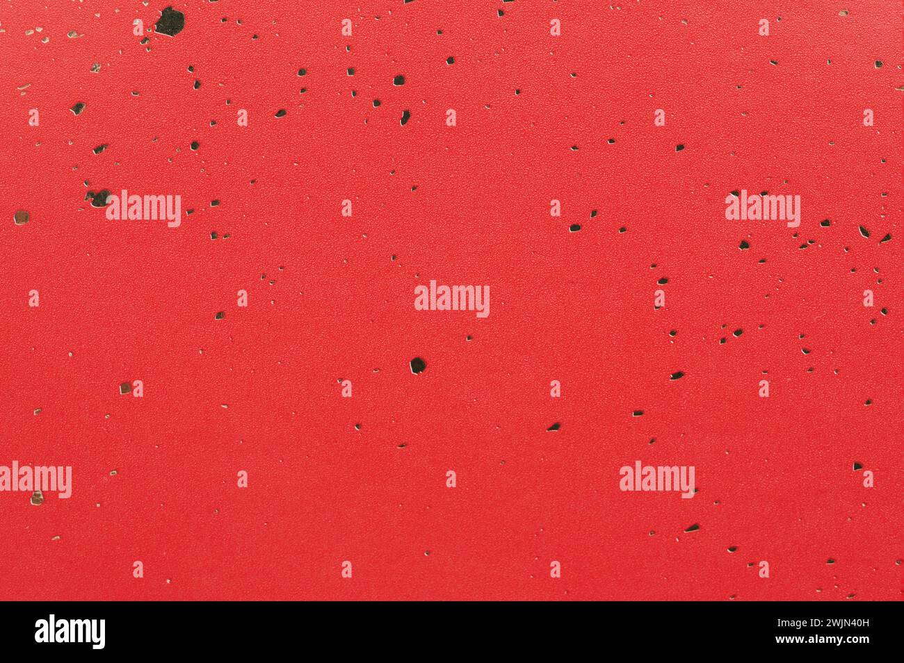 Rote Papierstruktur mit Goldfleck-Makroansicht Stockfoto