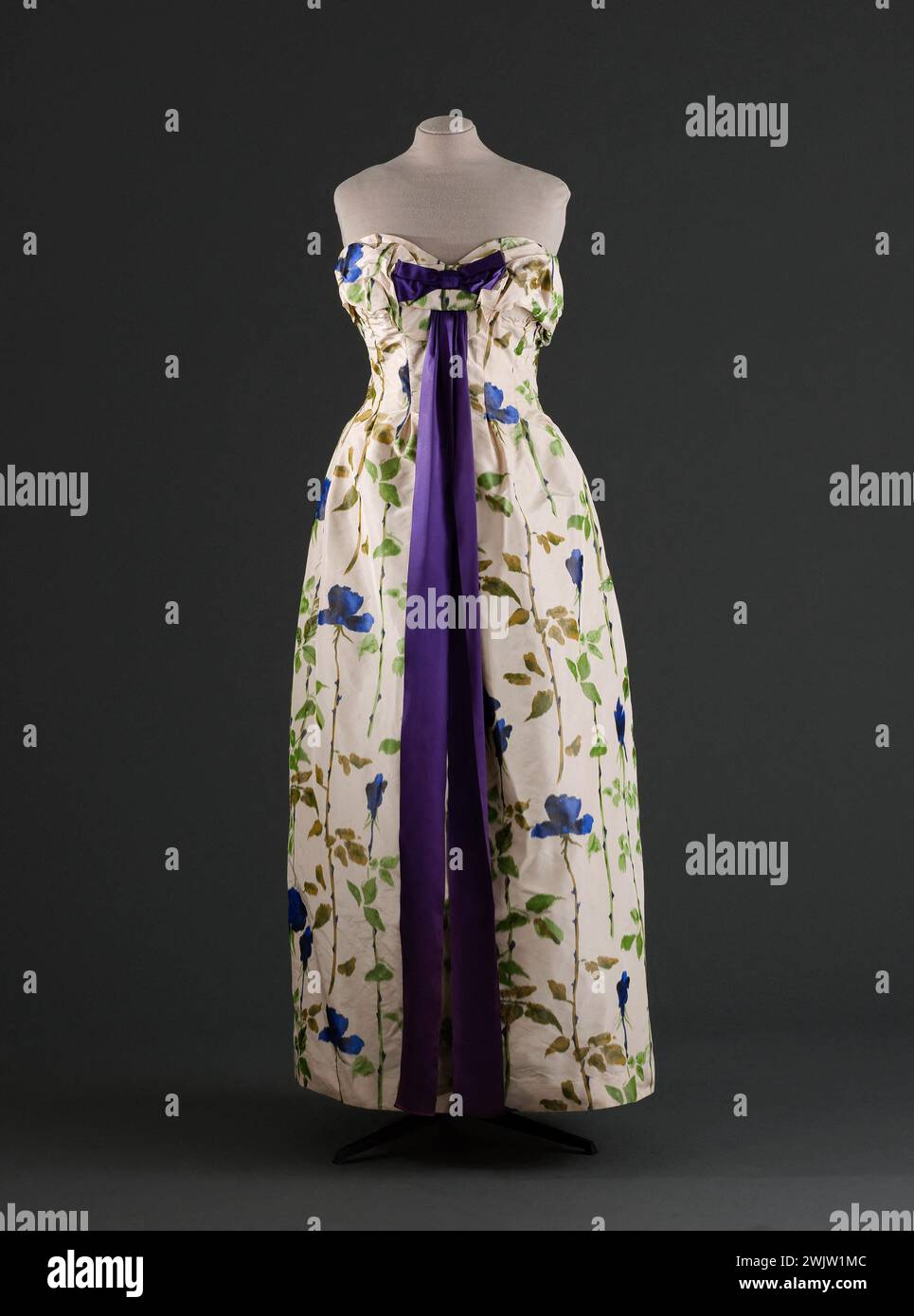 Jeanne Lanvin (1867-1946) und Castillo (Antonio Canovas del Castillo del Rey, dit) (1908-1984). Abendkleid. Marke: Jeanne Lanvin - Castillo. Taffeta auf Kette mit blauen Blumen (rosa) mit Stäben mit Stielen auf weißem Hintergrund des Staron Hauses, lila Satin. Frühjahr-Esté 1957. Galliera, Modemuseum der Stadt Paris. Annies Fifty 1950 50, blau, Kette, feminin, Frau, rosa Blume, Sternenhaus, Muster, Knoten, Abendkleid, Band, lila Satin, bedruckter Taft, Stiel Stockfoto