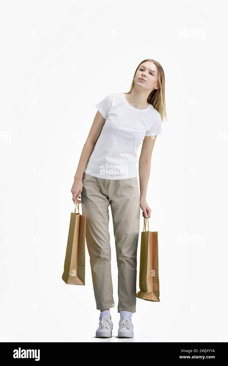 Eine Frau in voller Länge, auf weißem Hintergrund, mit Taschen Stockfoto