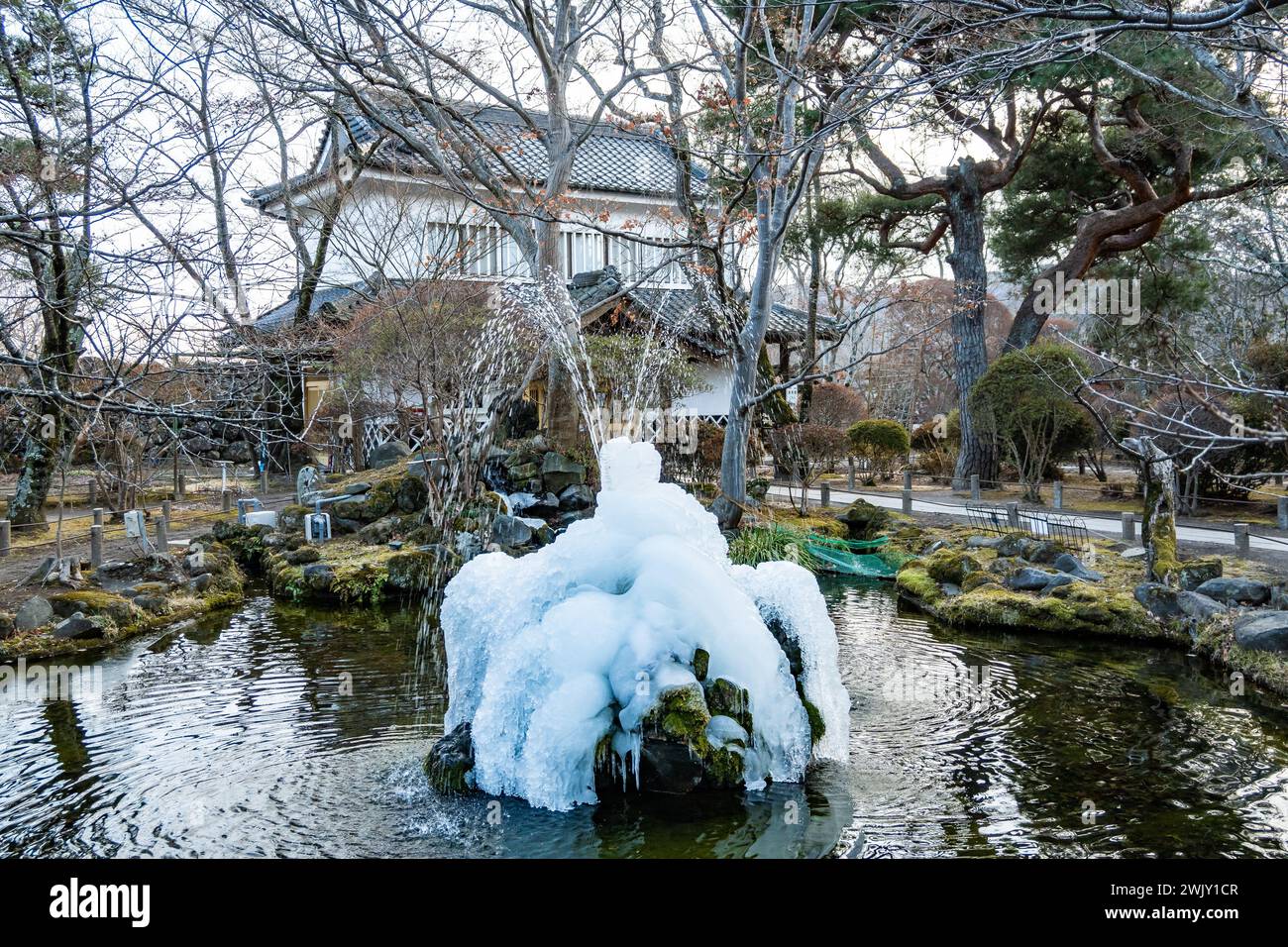 Eis bildete sich um den Wasserbrunnen an der Ruine der Burg Komorojō (小諸城址). Nagano, Japan. Stockfoto