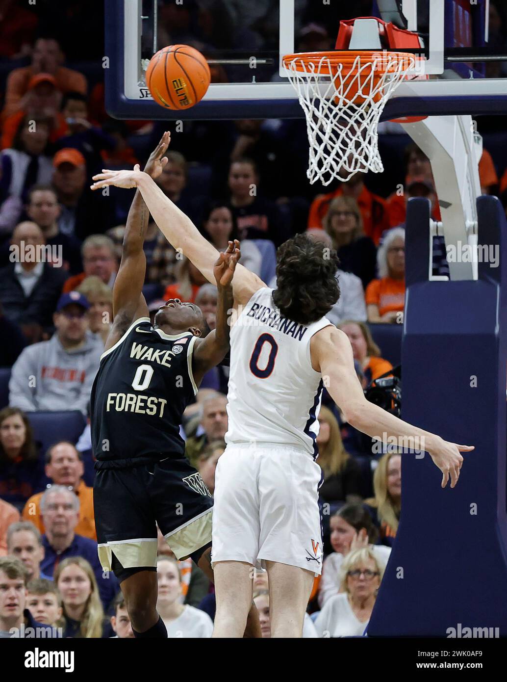 Charlottesville, VA, USA. Februar 2024. Virginia Cavaliers Stürmer #0 Blake Buchanan schlägt einen Wake Forest Demon Deacons Guard #0 Kevin Miller erschossen während eines NCAA Männer Basketballspiels zwischen den Wake Forest Demon Deacons und den University of Virginia Cavaliers in der John Paul Jones Arena in Charlottesville, VA. Justin Cooper/CSM (Bild: © Justin Cooper/Cal Sport Media). Quelle: csm/Alamy Live News Stockfoto