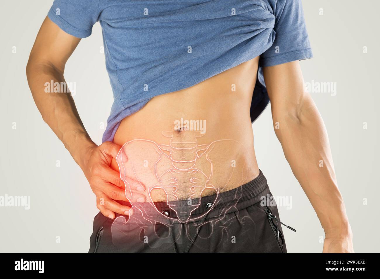 Beckenschmerzen des Menschen auf grauem Hintergrund. Stockfoto