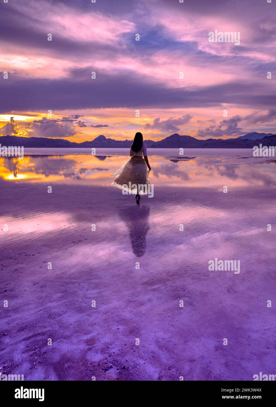Frau im traumhaften Sonnenuntergang am See Stockfoto