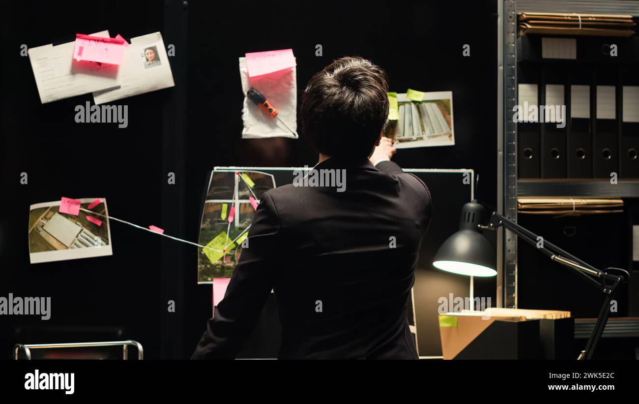 Agent, der Ermittlungsdienste für Strafverfolgung und Sicherheit durchführt und versucht, Straftäter zu finden, die illegale Aktivitäten begehen. Detective sammelt Informationen im Vorfallsraum. Handgeführte Aufnahme. Stockfoto