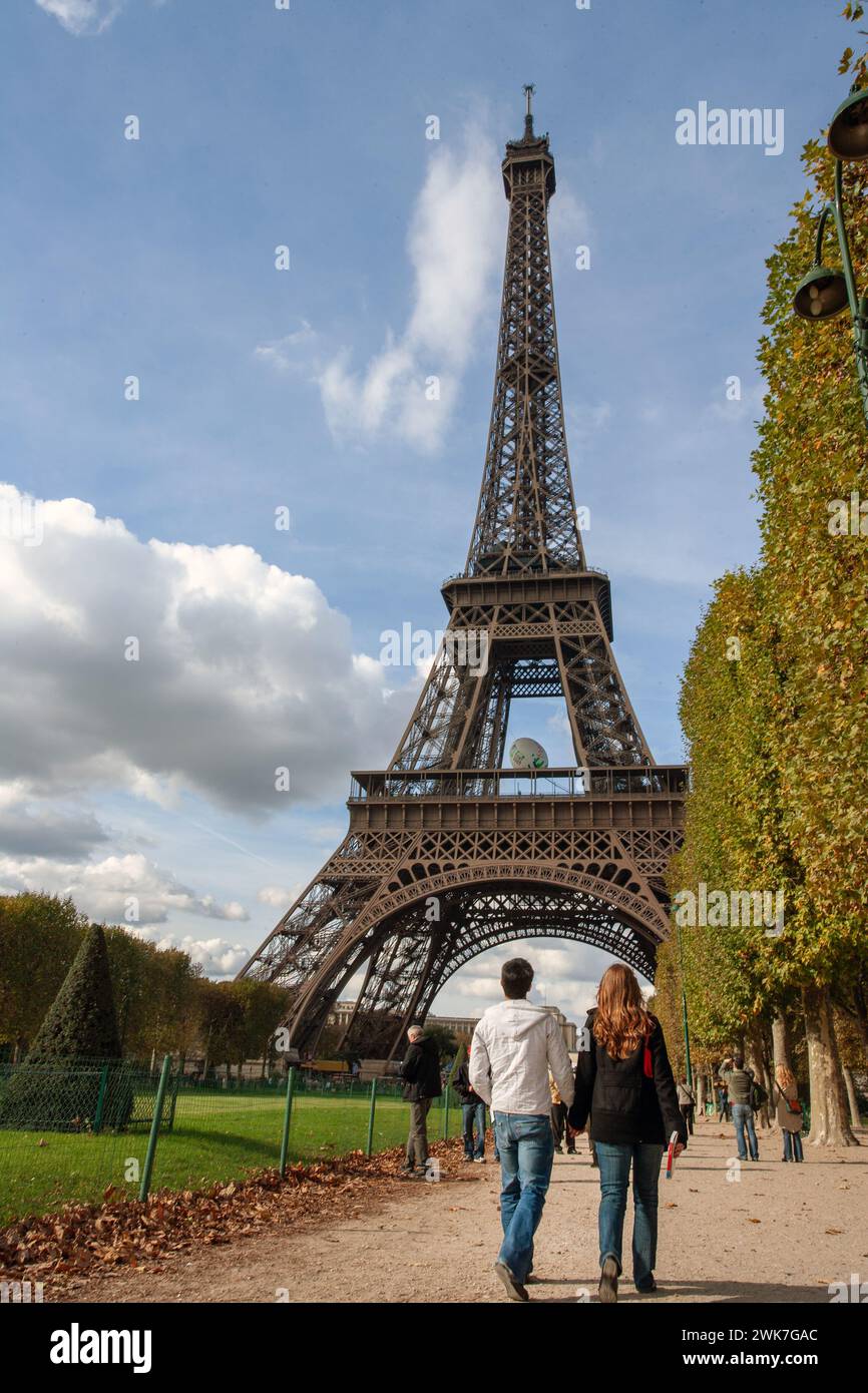 FRANKREICH / Ile de France / Paris /Paar zu Fuß mit dem Eiffelturm in der Ferne. Stockfoto