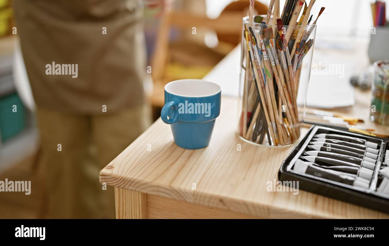 Hände einer angehenden hispanischen Künstlerin, die vor der Staffelei in ihrem gemütlichen Kunststudio steht und ihre Leinwand, Pinsel und Farbpalette vor sich herstellt Stockfoto