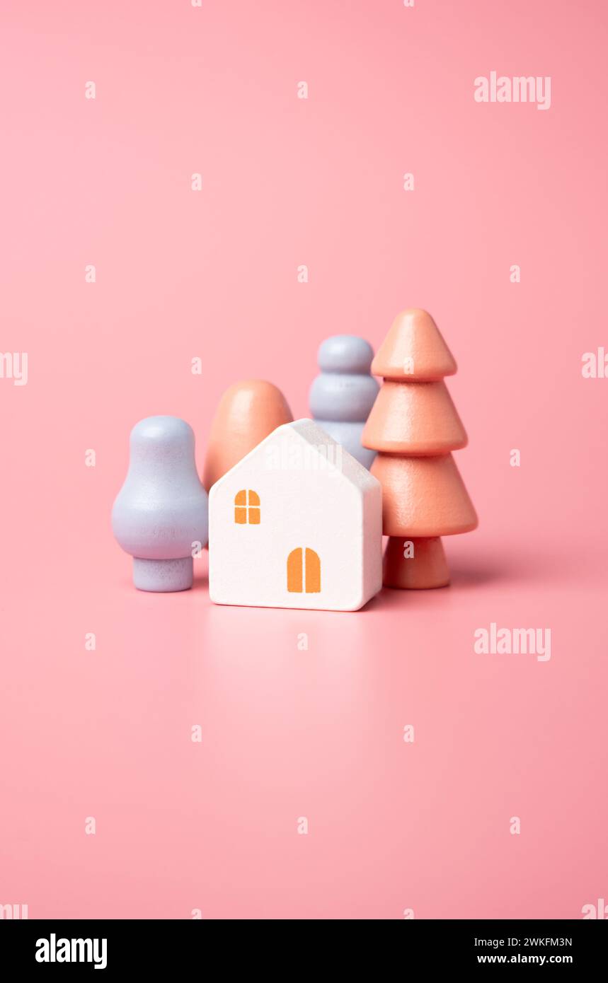 Häuser und Bäume in hübschen Farben. Hypotheken und Darlehen. Erschwingliche Wohnungen. Ich kaufe ein schönes Haus. Stockfoto