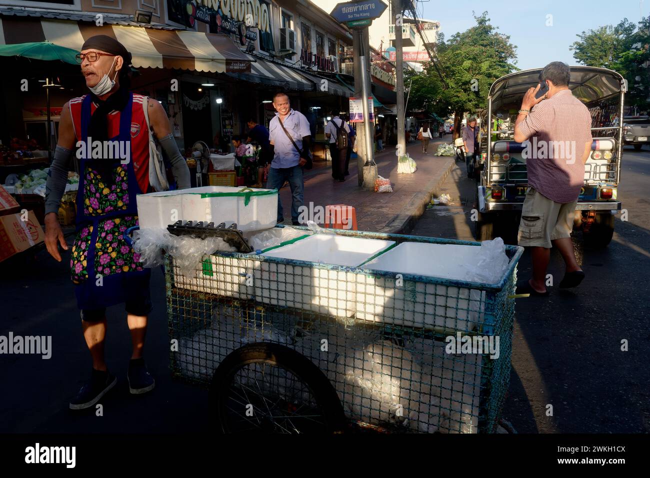 Ein mobiler Straßenverkäufer, der seinen Handwagen bei Pak Klong Talad (Talat/Talaat) in Bangkok, Südostasien, Thailand schiebt Stockfoto