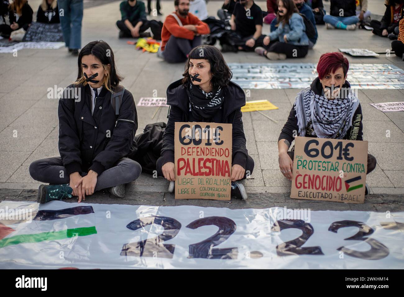 Madrid, Spanien. Februar 2024. Aktivisten mit Klebeband über dem Mund nehmen an einer Kundgebung gegen das Knebelgesetz Teil. Im Rahmen des Internationalen Tages der sozialen Gerechtigkeit fand auf der Plaza de Colón in Madrid eine Konzentration verschiedener Gruppen sozialer Bewegungen (Femen Spanien, Extinction Rebelion Madrid, Rebelion CientÍfica und mehr) statt. Sie haben die Aufhebung aller repressiven Gesetze und die Aussetzung aller Sanktionen, die gegen die Ausübung friedlichen Aktivismus verhängt werden, gefordert. (Foto: David Canales/SOPA Images/SIPA USA) Credit: SIPA USA/Alamy Live News Stockfoto