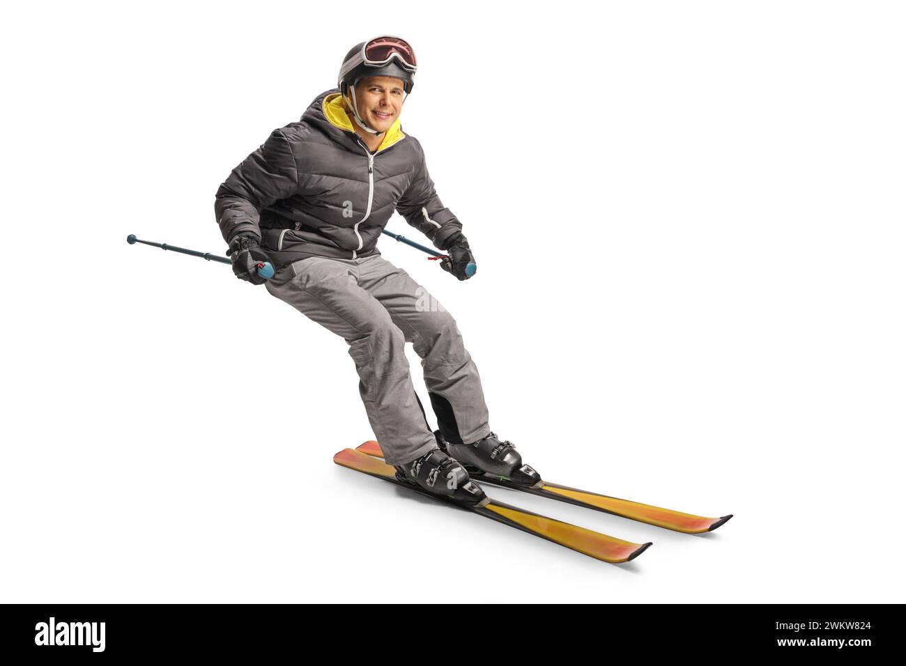 Mann Skifahren und zur Seite lehnen, isoliert auf weißem Hintergrund Stockfoto