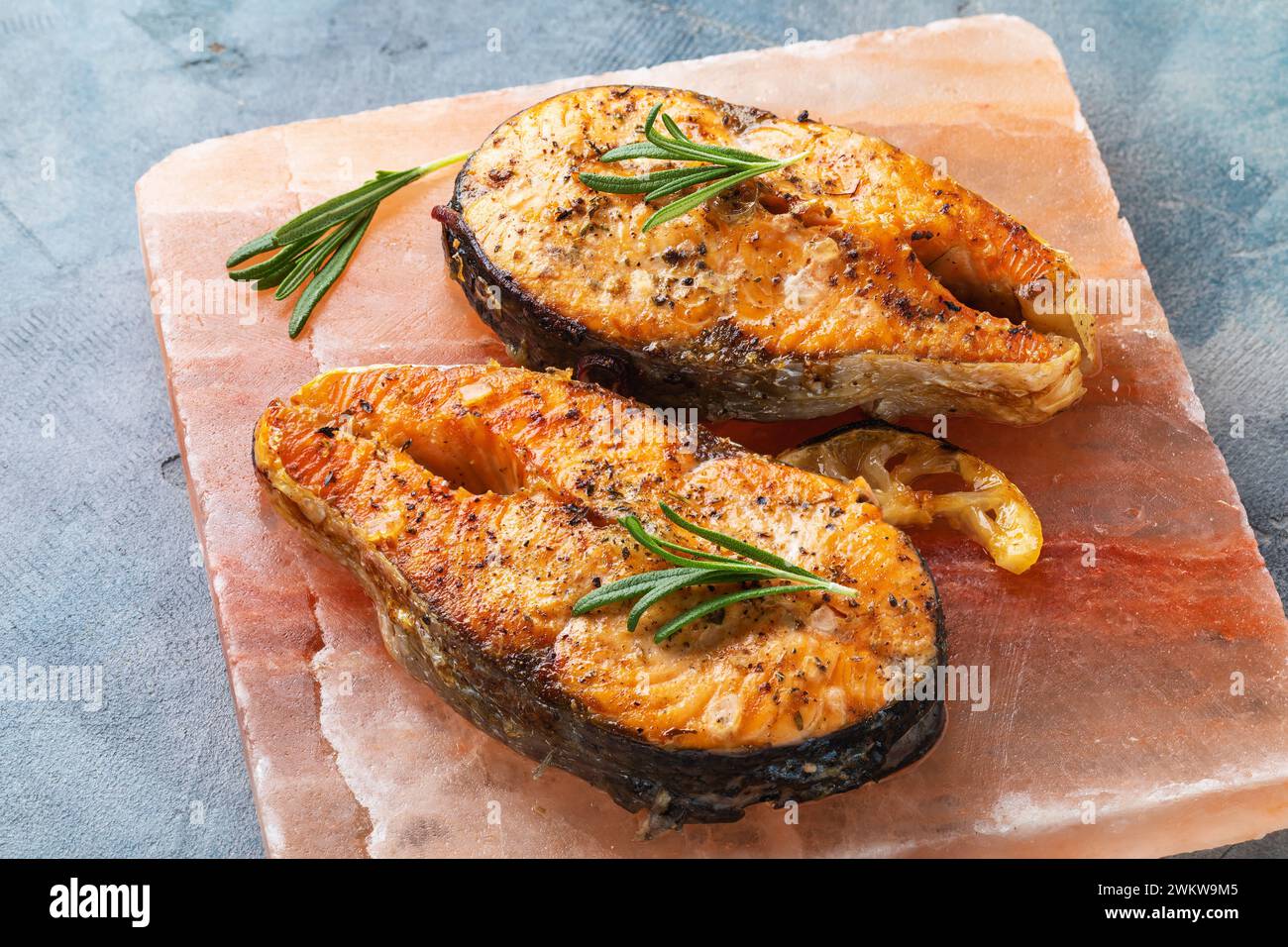Zwei gebackene rote Fischsteaks auf einer Salzplatte Stockfoto