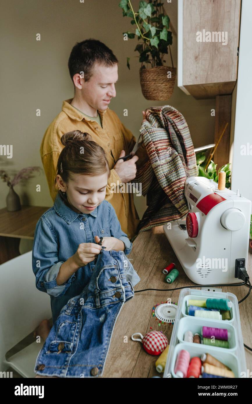 Vater und Tochter recyceln alte Kleidung zu Hause Stockfoto