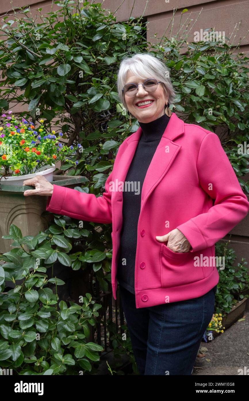 Ein attraktives Model, das mit einer pinken Marla Wynne Designerjacke posiert, New York City, USA 2024 Stockfoto