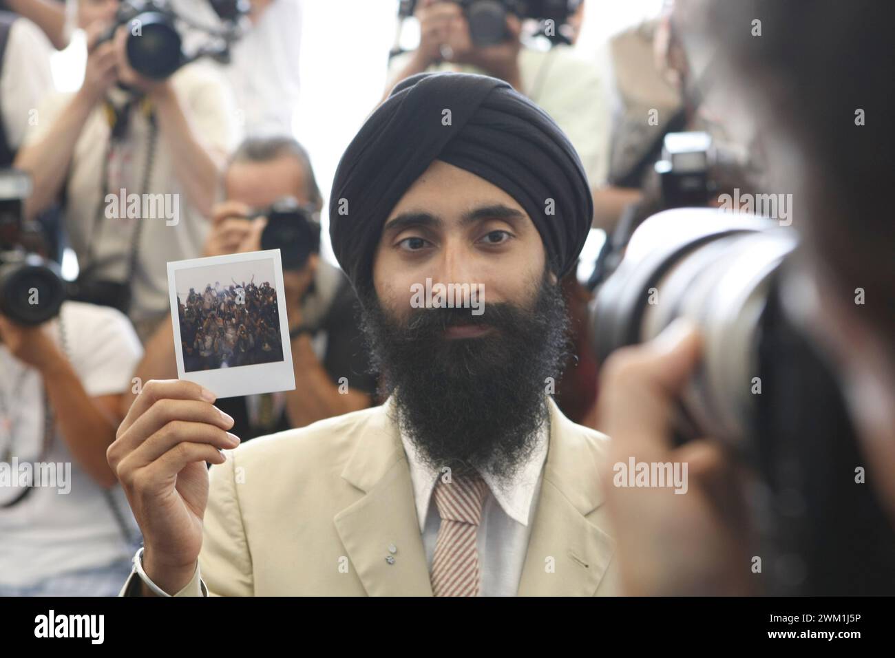 4069536 Venedig Lido, Venedig Filmfestival 2007. Schauspieler Waris Ahluwalia, in der Besetzung des Films "The Darjeeling Limited" von Wes Anderson, mit einem Polaroid-Foto der Fotografen, die gerade von ihm aufgenommen wurden (Foto); (add.info.: Venedig Lido; Lido di Venezia, Italien; Italia, 64 Filmfestival Venedig 2007 / 64 Mostra del Cinema di Venezia 2007 Lido di Venezia. Mostra del Cinema di Venezia 2007. L'atore Waris Ahluwalia, nel cast del Film "Il treno per Darjeeling" (The Darjeeling Limited) diretto da Wes Anderson, mentre mostra una polaroid dei fotografoi che ha appena scattato lui stesso); Stockfoto