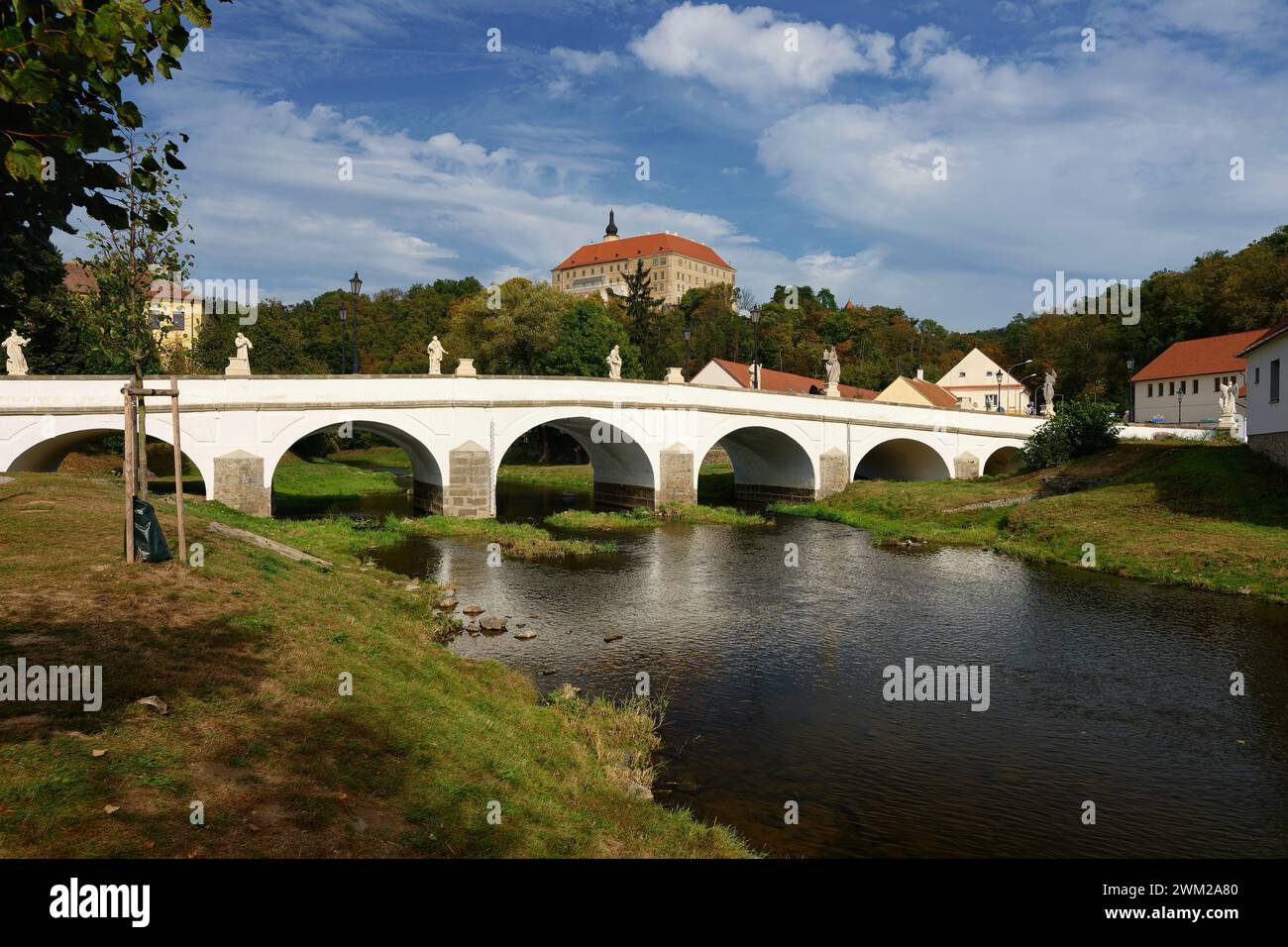 Wunderschönes altes Schloss mit einer Brücke über den Fluss bei Sonnenuntergang. Alte europäische Architektur. Namest nad Oslavou - eine Stadt in der Tschechischen Republik. Stockfoto