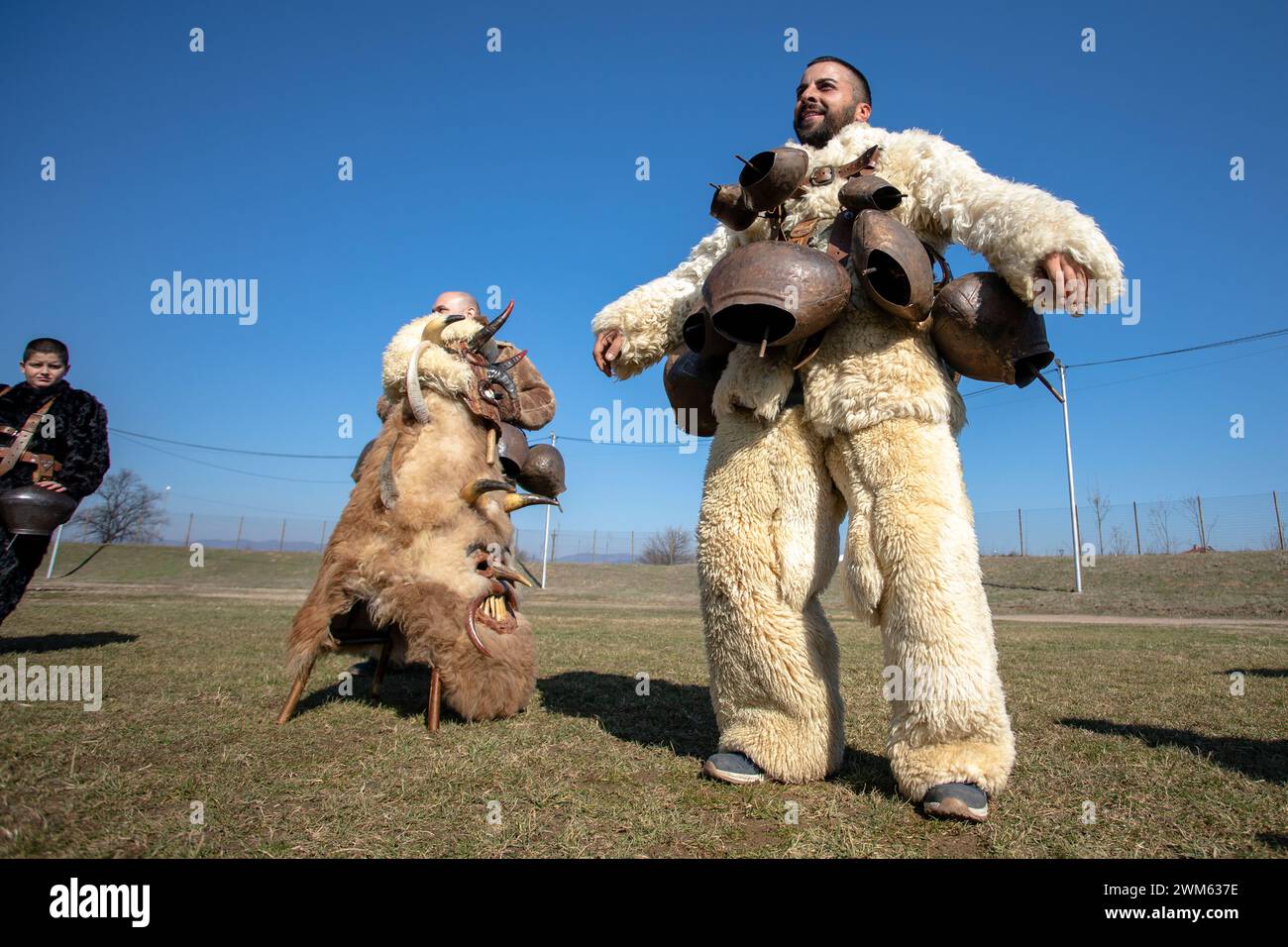 Elin Pelin, Bulgarien - 17. Februar 2024: Achte Ausgabe des Maskerade Festivals in Elin Pelin Bulgarien. Männer in Kukerkostüm mit Kupferglocken Stockfoto