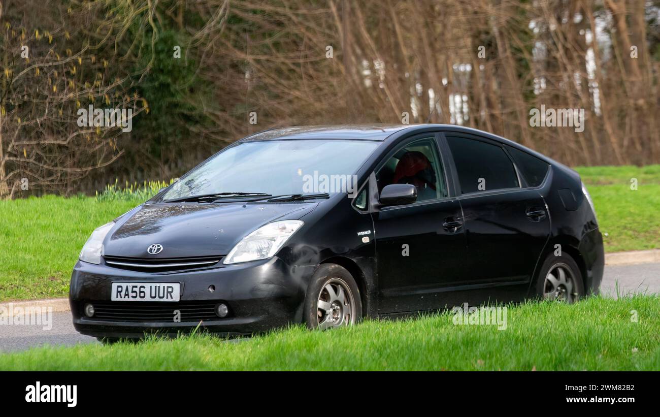 Milton Keynes, UK-Feb 24th 2024: 2007 schwarzes Toyota Prius Hybrid-Elektroauto, das auf einer englischen Straße fährt Stockfoto