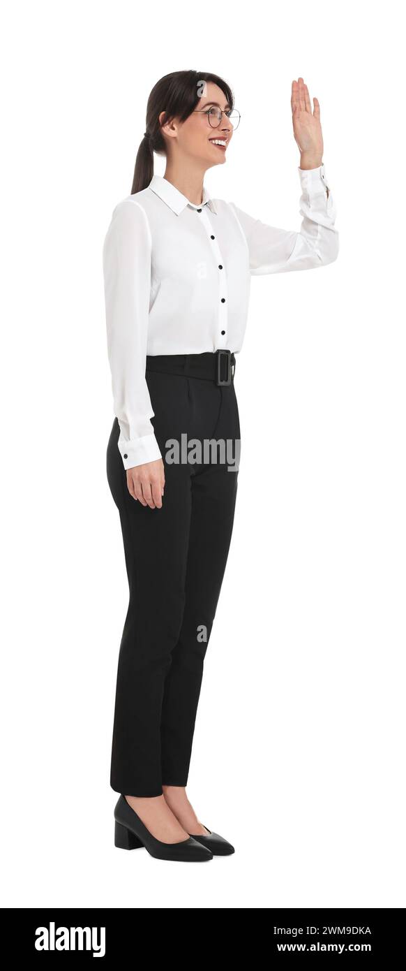 Glückliche Geschäftsfrau in Brille, die jemanden auf weißem Hintergrund begrüßt Stockfoto