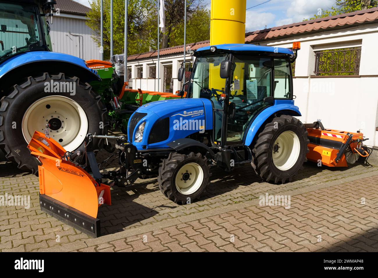 Vilnius, Litauen - 4. Mai 2023: Zwei neue Farmtraktoren New holland werden nebeneinander auf einem Verkaufsgebiet geparkt. Die Traktoren sind groß und langlebig. Stockfoto