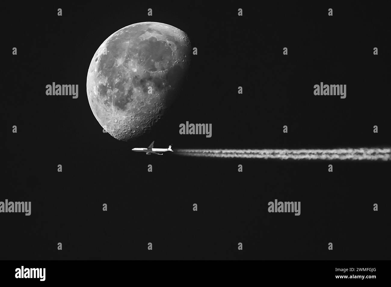 Flugzeug mit Kondensstreifen vor einem schwindenden Mond am frühen Morgenhimmel, Bayern, Deutschland, keine Montage Stockfoto