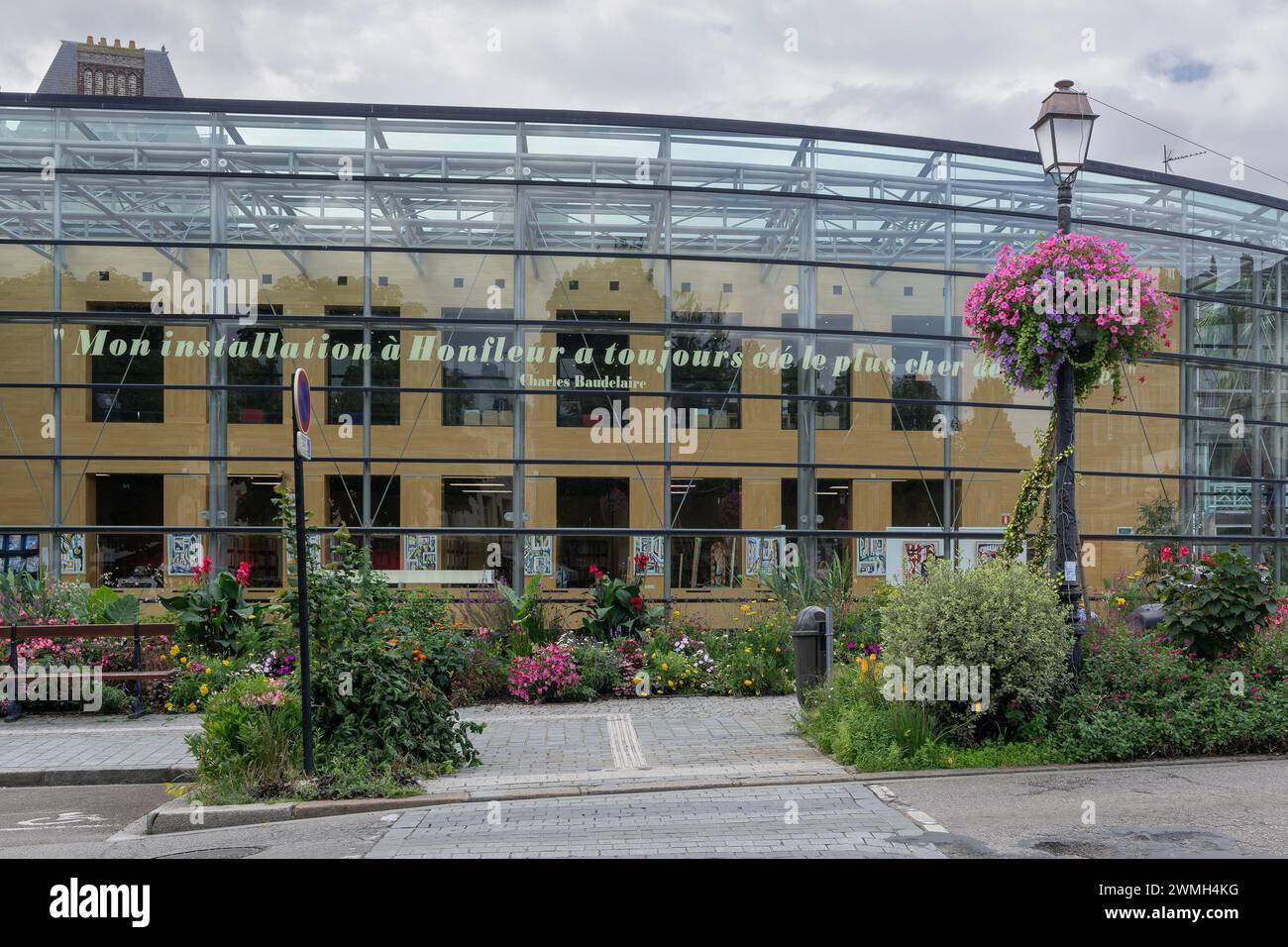 Honfleur, Frankreich - Schwerpunkt ist die Medienbibliothek Maurice Delange, ein moderner Glaskomplex mit großem Blumenbeet im historischen Stadtzentrum. Stockfoto