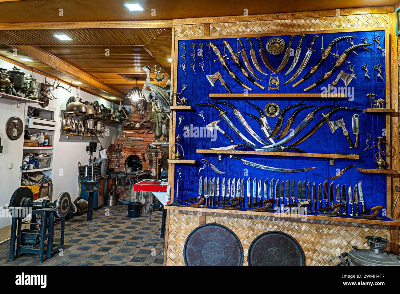 Verschiedene Messer und Schwerter in verschiedenen Formen im Souvenirshop. Herstellung von Kantenwaffen in der Schmiede. Buchara, Usbekistan. Stockfoto