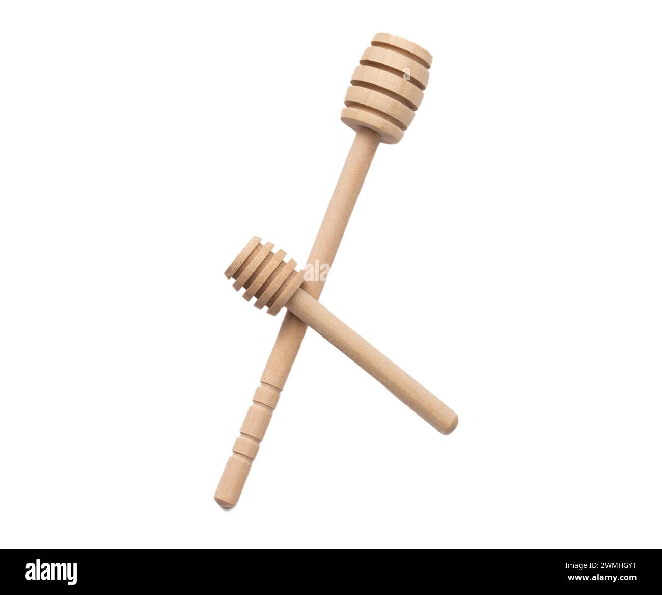 Ein großer und kleiner Honiglöffel auf weißem Hintergrund Stockfoto
