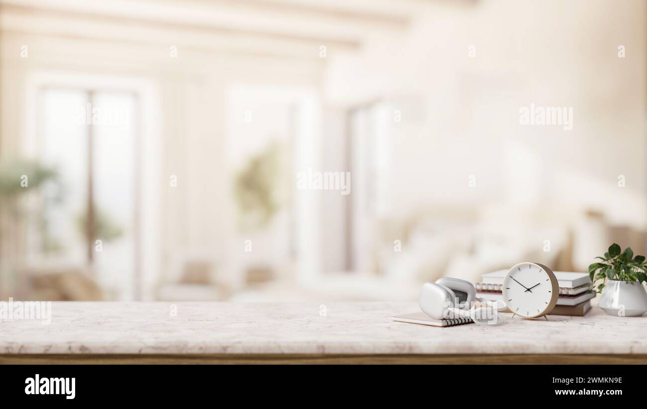 Eine luxuriöse Tischplatte aus weißem Marmor mit Kopfhörern, eine Uhr, Bücher, ein Dekorationspflanze und ein Kopierraum für Präsentationsartikel sowie ein verschwommenes elegantes Wohnzimmer Stockfoto