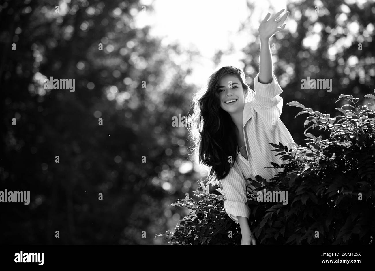 Freundliche Frau sagen Hallo Grüße auf Natur Hintergrund im Sommer oder Frühling Park. Stockfoto